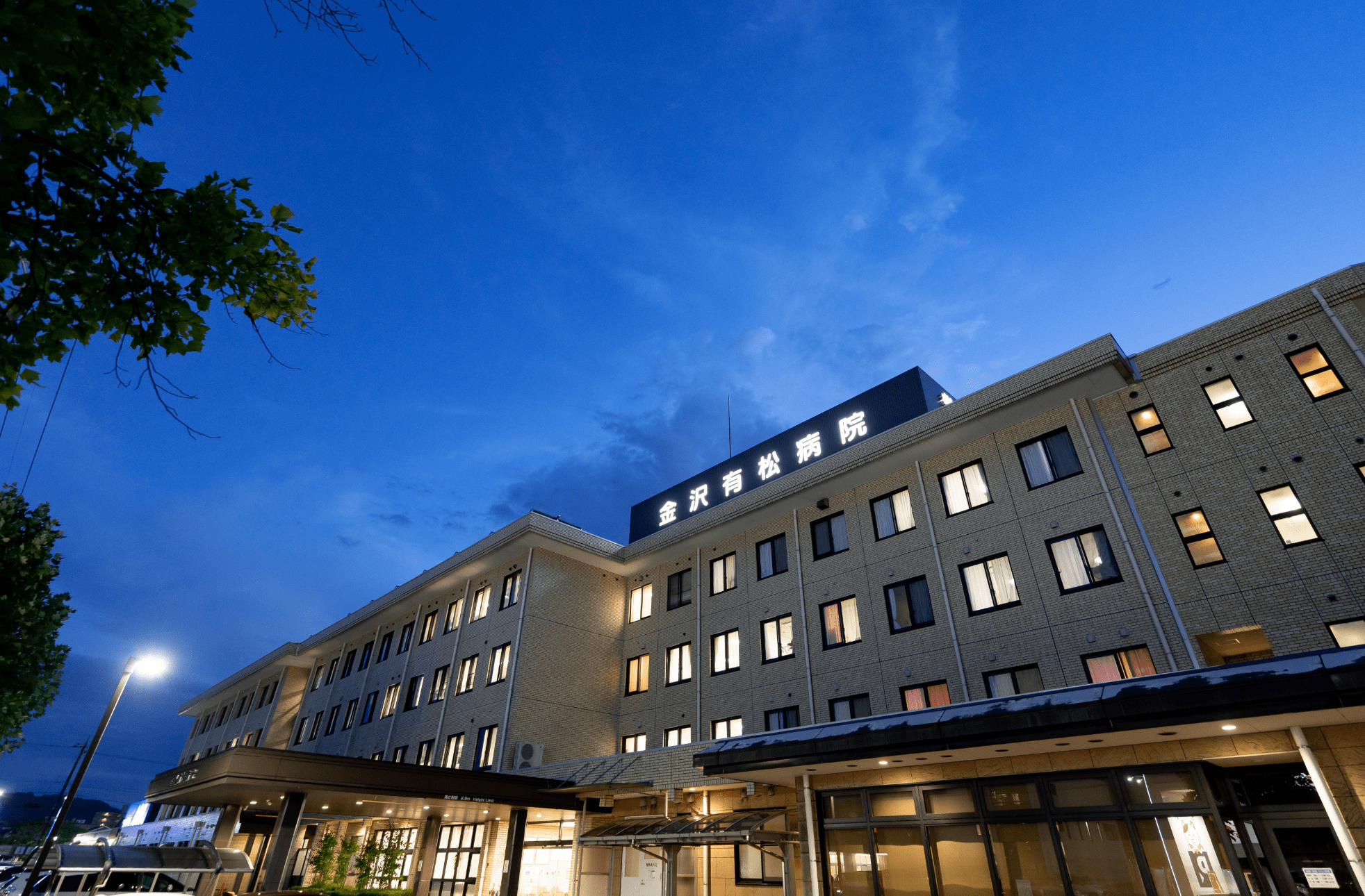 ライトアップされた夜の病院の外観の画像